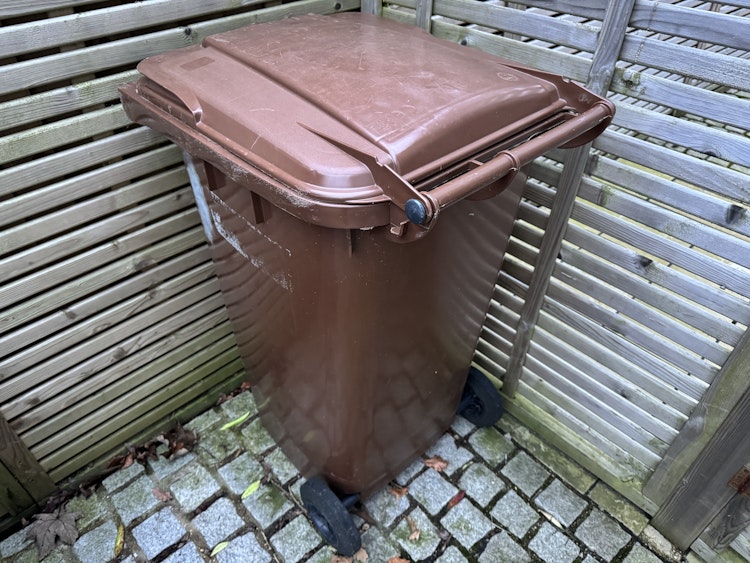 A brown garden waste bin
